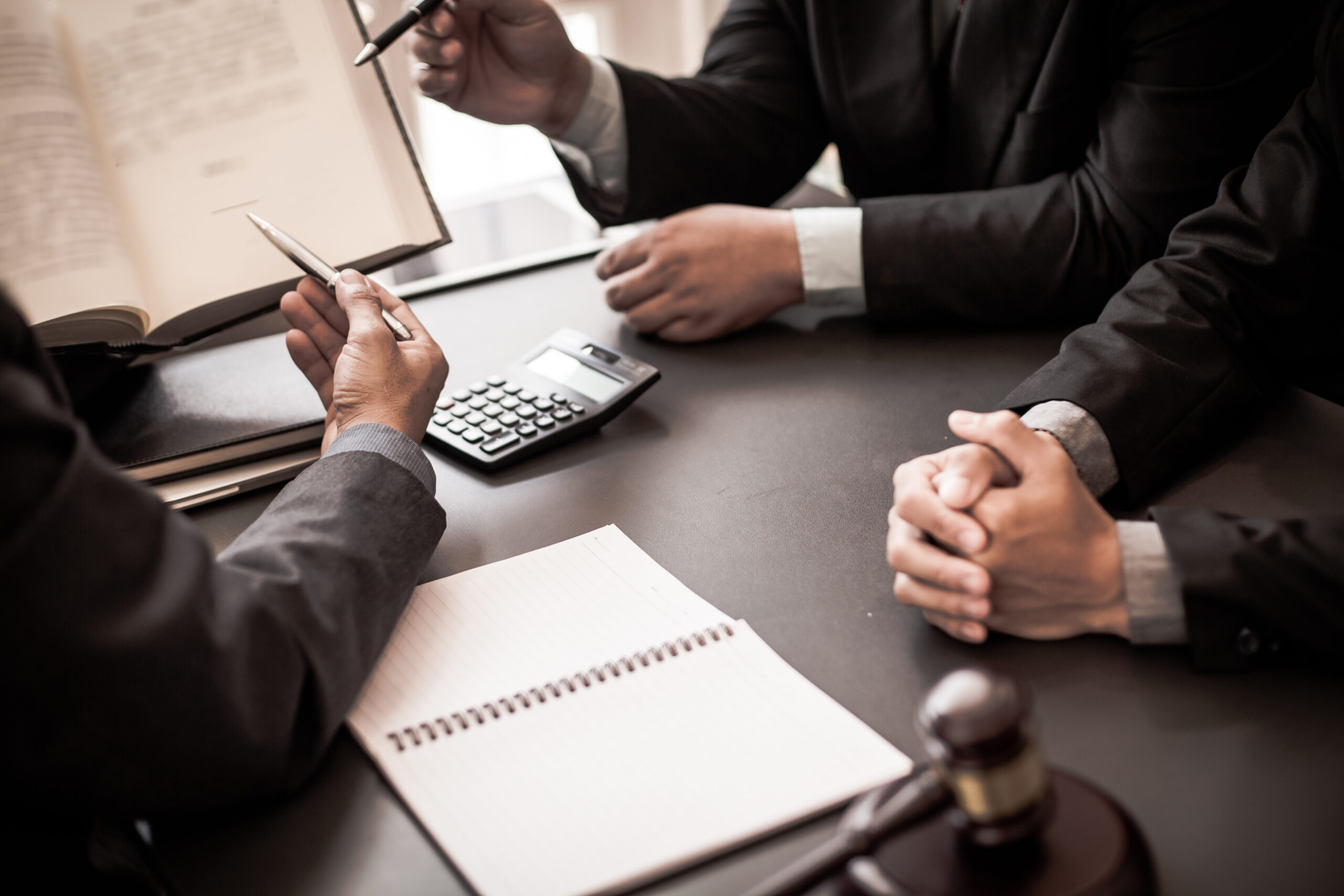 Group of business people and lawyers discussing contract papers